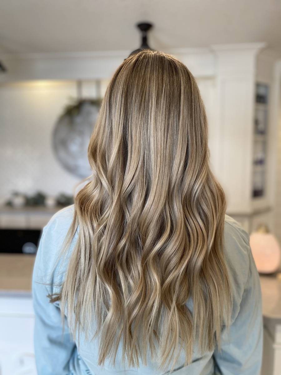 Long blonde balayage waves styled at Danae's 4th Street Salon